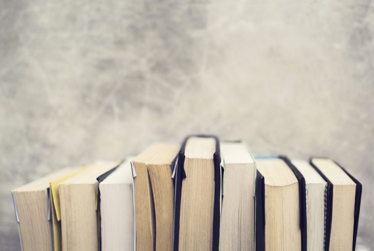 Series of books at concrete wall background