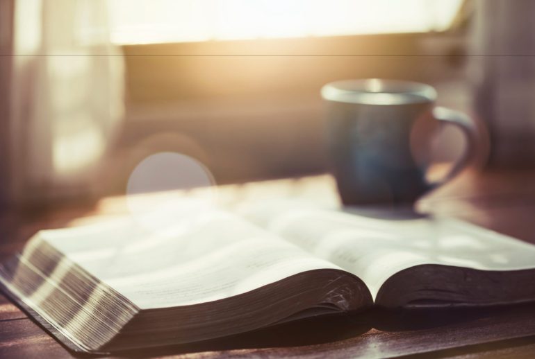 Close,Up,Of,Open,Bible,With,A,Cup,Of,Coffee