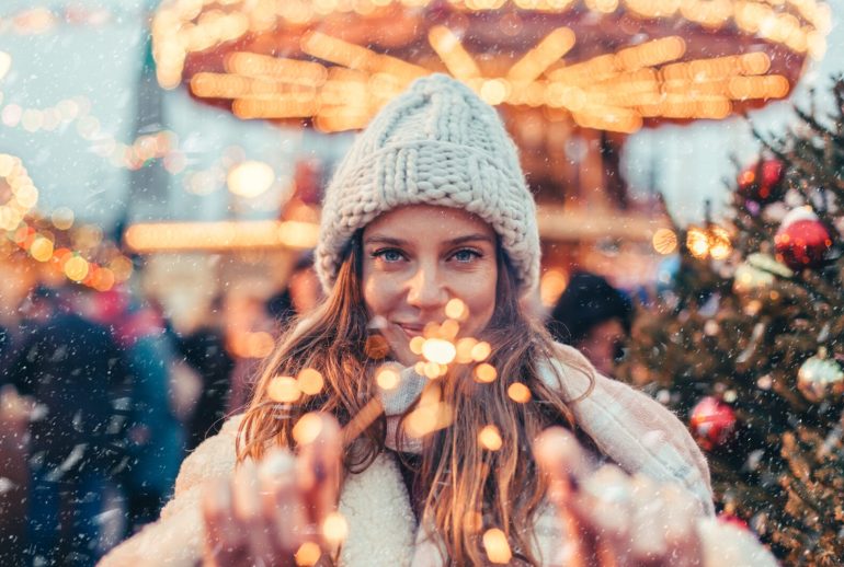 Girl,Walking,In,Christmas,Market,Decorated,With,Holiday,Lights,In