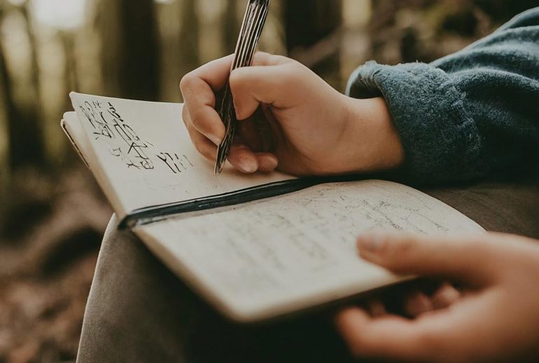 Person,Journaling,In,The,Woods